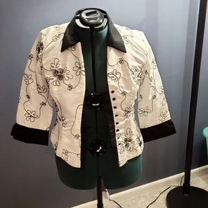 Taffeta-like embroidered white jacket.